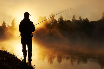 fisher fishing on foggy sunrise - obrazy, fototapety, plakaty