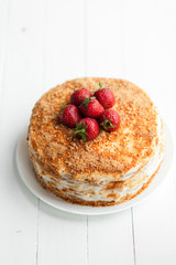 Creamy pie with fruits on table