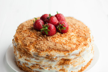Creamy cake with fruits on table