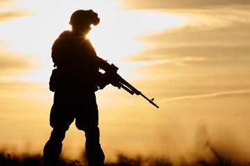 Military soldier silhouette with machine gun 