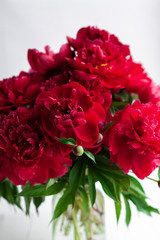 Red peony bouquet on table