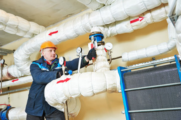heating engineer repairman in boiler room