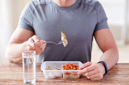 Close Up Of Man With Fork And Water Eating Food