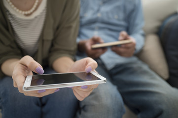 Men and women are watching the mobile phone