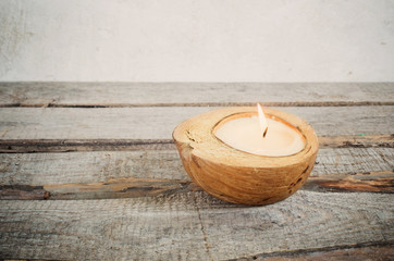 Obraz na płótnie Canvas Candle in a coconut shell
