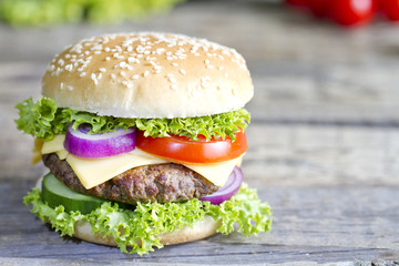 Hamburger on vintage wooden board closeup