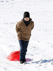 Fototapeta na wymiar boy plays with bob on the snow in the mountains