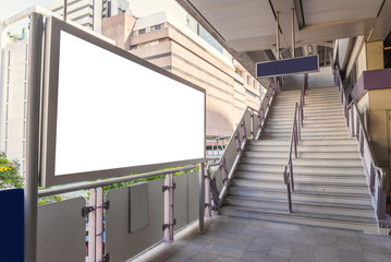 large blank billboard on overpass with city view background