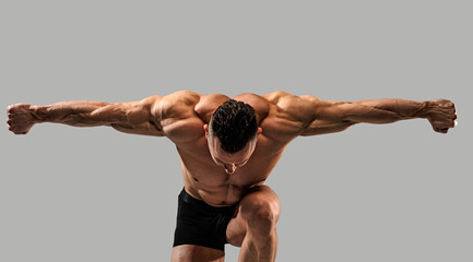 Bodybuilder on grey background