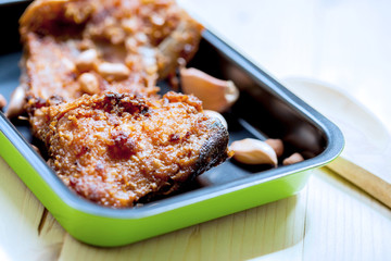 fish fillet fried in the pan on wood