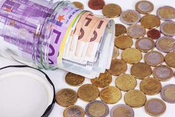 Glass with paper money and coins