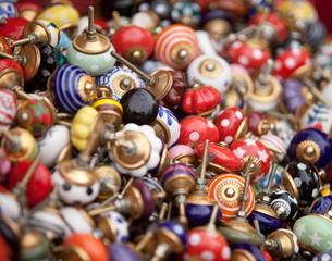 Fototapeta na wymiar The heap of colorful doorknobs at flea market