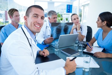 Fototapeta premium Team of doctors working on laptop and analyzing xray