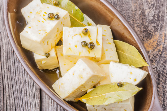 Goat feta cheese with oil in bowl