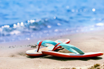 Flip flops alone on a sandy beach