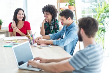 Fototapeta premium Casual businessman typing on his laptop