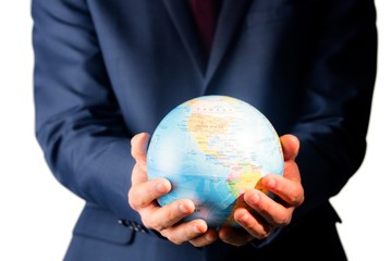 Hand of businessman holding terrestrial globe 