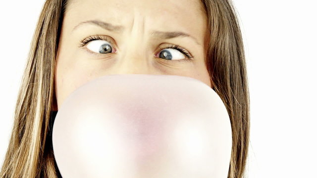 funny girl making bubble with chewing exploding laughing