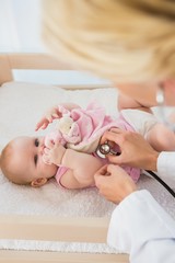 Obraz na płótnie Canvas Beautiful cute baby girl with doctor with stethoscope