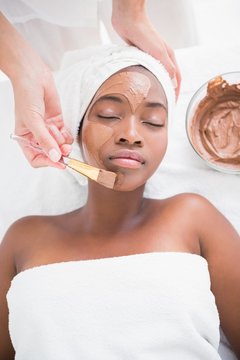 Pretty woman getting a chocolate facial treatment