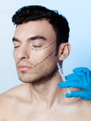 Filling wrinkles, crow's feet, injection of hyaluronic acid . Portrait of a handsome man during the treatment of facial wrinkles filling, Cosmetic is injected into facial skin cosmetics 