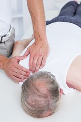 Fototapeta na wymiar Physiotherapist doing shoulder massage to his patient