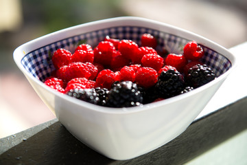 Raspberries and blackberries in a bowl