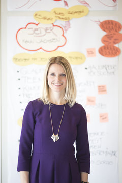 Portrait of smiling woman in front of her conception