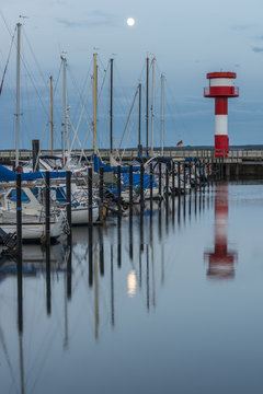 Germany, Eckernfoerde, harbor with lighthouse at full moon
