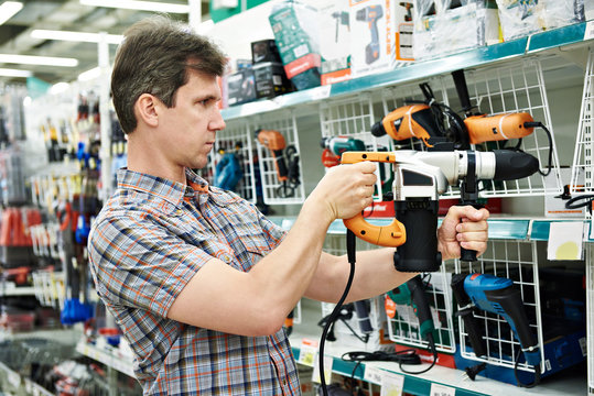 Man shopping for perforator in hardware store