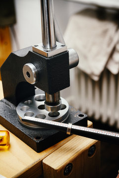 Goldsmith working on wedding rings, ring on ring mandrel and appliance