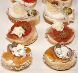 Mini sandwiches - bread with cream cheese, smoked salmon, and vegetables