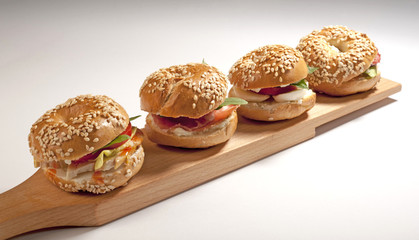Mini  bagel sandwich with tomato cheese and ham 