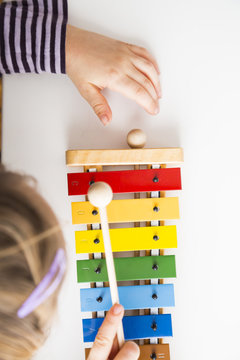 Little girl playing xylophones