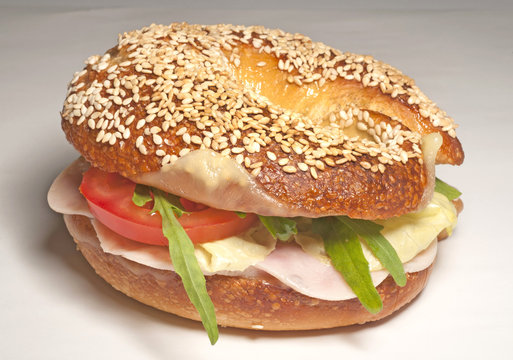 Big bagel sandwich with tomato cheese and ham