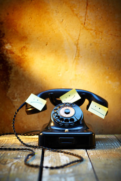 Black old Bakelite telephone with adhesive notes