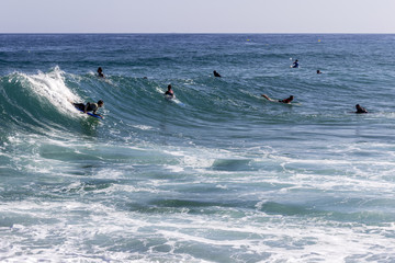Ocean view and people surfing in Tavira Island, Algarve