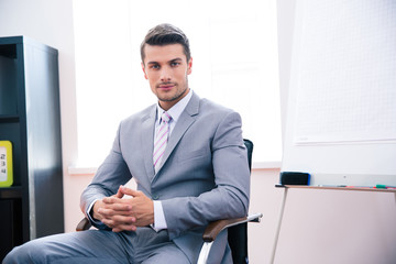 Handsome businessman sitting on the office chair