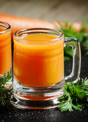 Fresh carrot diet  juice  in old-fashioned glass mug, selective