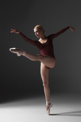 Fototapeta premium Young beautiful modern style dancer posing on a studio