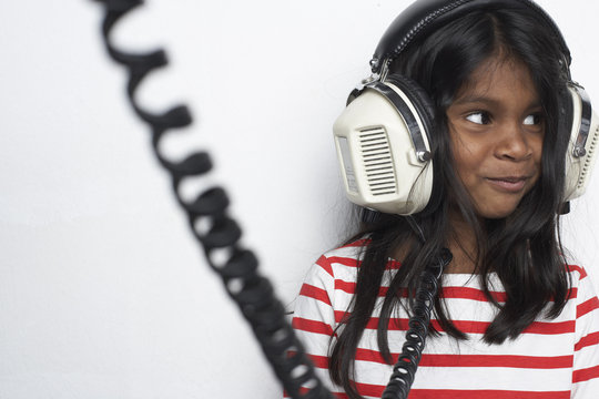 Portrait of smiling girl hearing music with headphones