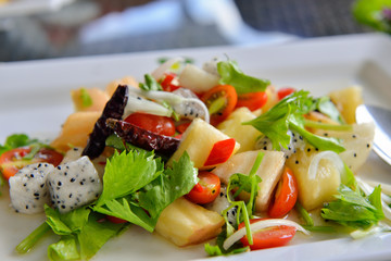 Fresh tropical fruit salad in white plate . Thailand style
