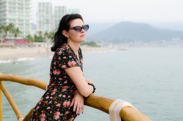 Young attractive Caucasian  woman enjoys sun on ocean resort 