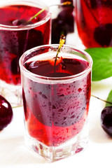 Homemade cherry liqueur and fresh cherries, selective focus