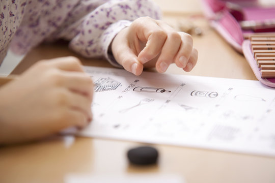 Schoolgirl working on work sheet in classroom