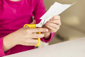 Girl cutting piece of paper