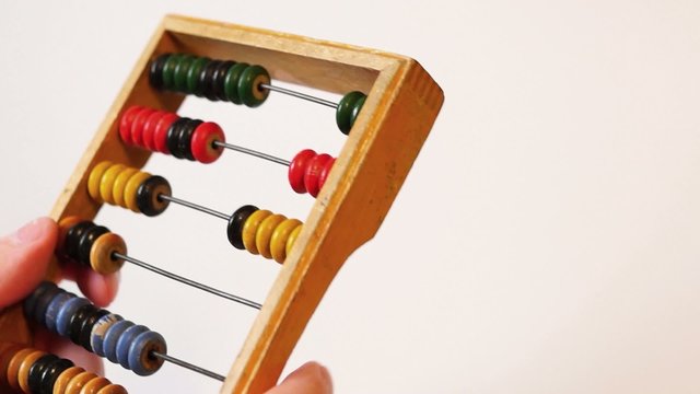 Hands make calculations on abacus