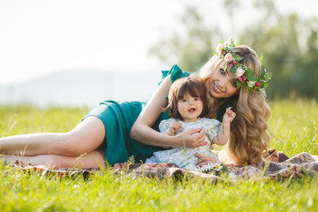 Fototapeta premium Happy woman with a child resting on the nature
