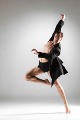 The young attractive modern ballet dancer on white background