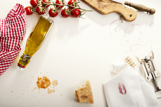 Italian Food, Olive oil bottle, baguette, napkin with lipstick, corkscrew and tomatoes